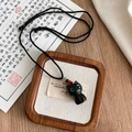 Ebbenhouten gelukskat hanger ketting met blauwe edelstenen ogen en gevlochten touw - Ebbenhouten kitten kettingen