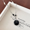 Minimalistische ketting met zwarte stenen donut hanger en zilveren verstelbare ketting - Zwarte Steen Halsketting