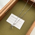 Silver cylinder chain necklace featuring a transparent glass ball with dried flowers - Transparent Glass Bead Necklace