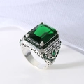 Vintage silver-tone ring with emerald-cut green gemstone and intricate hollow carving - US 7 / Green