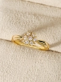 Primer plano de anillo de flor dorada con circones blancos en tela beige - US 6 / Dorado
