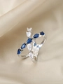 Detail of cross teardrop ring with alternating blue and white pear-cut cubic zirconia - US 6 / Silver