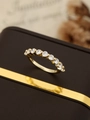 Macro detail of gold eternity ring with nine round diamonds set on a jewelry box - US 8 / Gold