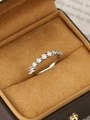 Macro close-up of a silver band ring with eleven sparkling claw-set round cubic zirconia - Silver