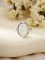 Macro view of vintage silver ring with oval white opal and halo of white zircons - US 6 / Silver