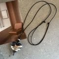 Detail of silver-wrapped black heart pendant with natural wood texture and wax cord - Dark Wood Heart Wrapped Necklace