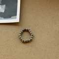 Polierter silberner Perlenring mit glänzenden Metallkugeln auf Vintage-Hintergrund - Titanstahl Perle Elastisches Seil Ring