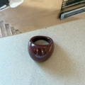 Detail of a wide dome ring in polished burgundy enamel with a sleek mirror finish - Wide Resin Style / Burgundy
