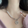 Macro shot of a baroque pearl and silver link chain necklace with a heart pendant - Freshwater Pearl Heart Pendant Style (Style 1)