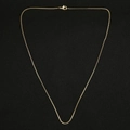 Close-up of polished golden box chain necklace with a secure lobster clasp closure - 45cm / Box Chain / Gold