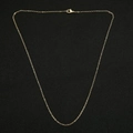 Close-up of golden O-link snake bone chain with lobster clasp on black background - 45cm / O Chain / 1mm / Gold