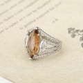 Macro detail of marquise-cut amber gemstone and vintage hollow silver band with micro-pave - US 6 / Silver