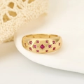 Star-set gold ring featuring thirteen red rubies on a polished band for women - US 6 / Gold
