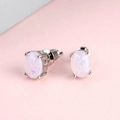 Macro detail of oval opal stud earrings in silver four-claw setting with backings - White Opal 6*8mm