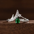 Macro detail of crown ring featuring a pear-cut green sapphire and sparkling zirconia - US 6 / Green