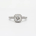 Detail macro view of a halo engagement ring with circular center stone and pave diamonds - US 5 / Silver
