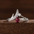 Crown-shaped copper ring with pear-cut red sapphire and pavé diamonds on dark wood - US 6 / Red