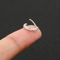 Silver cartilage piercing hoop with cubic zirconia pave inlay shown on fingertip - 10mm / Silver
