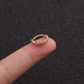 Rose gold micro-pave zircon hoop earring for cartilage piercing held on a fingertip - Style 1 Rose Gold