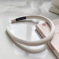 Detail of cream fabric headband with thick sponge padding and Hand Made woven label - Off White