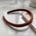 Close-up of brown twill fabric headband with handmade label and high-quality texture - Caramel color