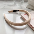 Detail of beige fabric headband with HAND MADE label and elegant minimalist texture - Milk Tea