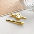 Juego de dos pinzas para el cabello doradas con carita sonriente y grabado Smile - Dorado
