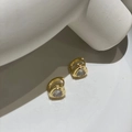 Golden huggie earrings with heart-shaped sparkling zircon on white stone background - Ear Buckle / Gold with White Zirconia