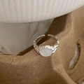 Detail of adjustable silver feather ring featuring irregular hammered texture and white opal - Silver Cat Eye Ring