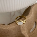 Close-up of gold-plated feather ring with white cat eye stone and hammer texture details - Gold Cat Eye Ring