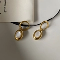 Detailed close-up of 18K gold-plated oval white shell drop earrings on a minimalist background - Ear Buckle / Gold