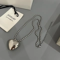 Detailed shot of silver heart pendant with oval bead chain on elegant gray background - 50cm+10cm / Hollow Heart Necklace / Silver
