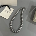 Close-up of gray faux pearl necklace with silver lobster clasp and adjustable metal chain - Imitation Pearl Necklace / 10mm / Gray