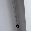 Detail of minimalist black resin circle pendant necklace with silver beads on black cord - Obsidian with Three Steel Beads