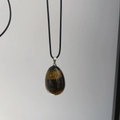 Polished egg-shaped tiger eye stone pendant necklace with minimalist black cord - Tiger's Eye