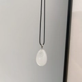 Minimalist white teardrop natural stone pendant necklace with a black cord strap - White Crystal