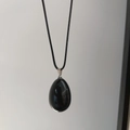 Minimalist egg-shaped black natural stone pendant with silver clasp on black cord - Obsidian
