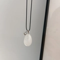 Minimalist egg-shaped white natural stone pendant necklace on a black waxed cord - White Crystal (With Silver Bead)