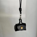 Mini black leather pouch necklace with gold clasp and woven strap for headphones - Black