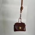 Mini dark brown leather earphone pouch with snap closure and long neck strap lanyard - Brown
