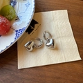 Chic silver-plated heart-shaped hoop earrings displayed in a lifestyle setting - Silver Heart Style (925 Silver Post)
