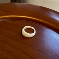 Minimalist creamy white irregular resin ring on a wooden tray with a smooth finish - Irregular Narrow Resin Ring / Beige