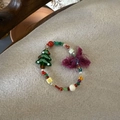 Handmade Christmas beaded bracelet featuring a green tree charm and purple tassel - Green Christmas Tree Tassel Style