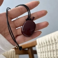 Oxblood red pebble pendant necklace with long black cord in a glossy polished finish - Bottle Pendant / Black Braided Rope / Red