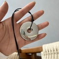 Handheld minimalist silver ring pendant on a black adjustable cord necklace - Large Safety Buckle / 4.5cm / Black Braided Cord / Silver