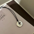 Silver circle pendant necklace with black cord on a soft pink book cover - Small Safety Buckle / 3.3cm / Black Braided Cord / Silver