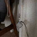 Silver metal woven pendant necklace with polished heart charm and textured square bead - Black Leather Cord Hollow Metal Bag Necklace