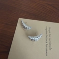Polished silver croissant stud earrings on display card with black leather cord detail - 925 Silver Earring Post / Silver Croissant Stud Earrings
