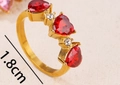 Golden ring featuring three red heart crystals and tiny diamonds with 1.8cm diameter - US 7 / Red Zirconia Gold Ring