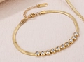 Gouden titanium stalen slangenarmband met tien fonkelende ronde zirkonia steentjes - Gouden Slangenbot Ketting Armband